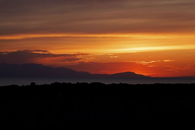 Scenic view of silhouette landscape against romantic sky at sunset