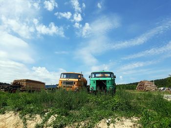 Abandoned truck on field against sky