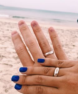 Cropped hands of couple at beach