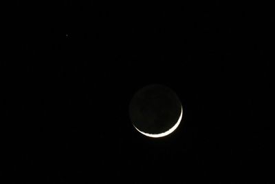 Low angle view of moon against sky at night