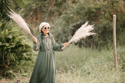 Woman standing by tree