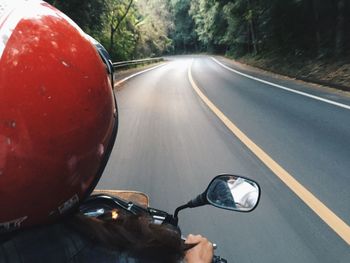 Rear view of woman riding scooter