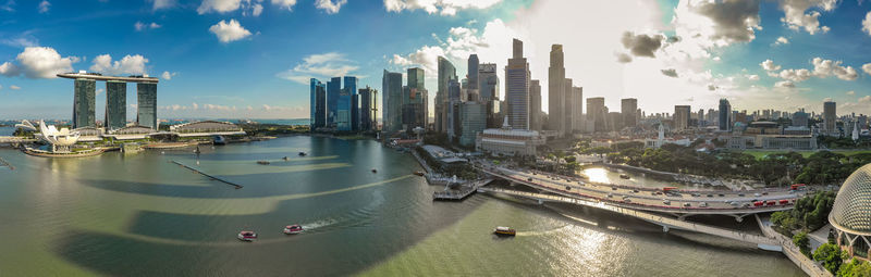 Panoramic view of sea and modern buildings against sky
