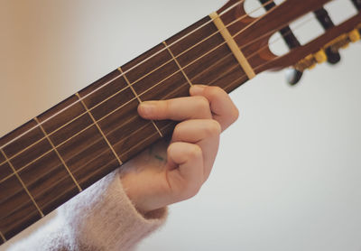 Little girl plays the guitar.