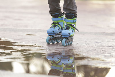 Low section of person standing on umbrella