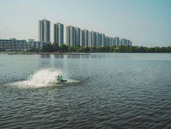 View of city by sea against clear sky