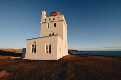 Lighthouse against clear blue sky