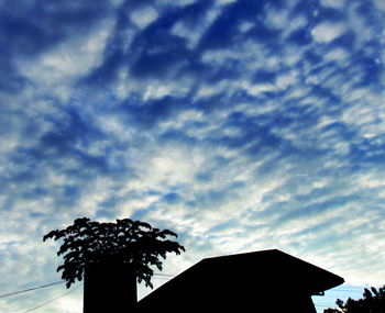 Low angle view of building against cloudy sky