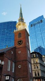 Low angle view of clock tower against sky