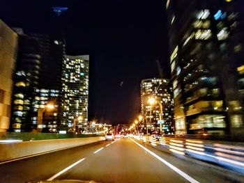 Light trails on road in city at night