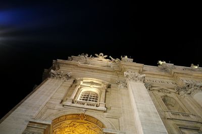 Low angle view of illuminated building at night