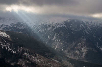 Aerial view of snowcapped mountains against sky