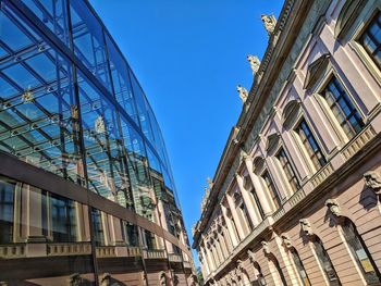 Low angle view of buildings against clear blue sky