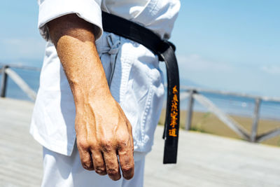 Karate expert with relaxed hands, close up image