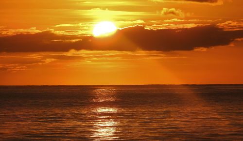 Scenic view of sea against orange sky