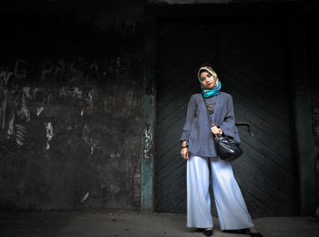 Woman standing against wall