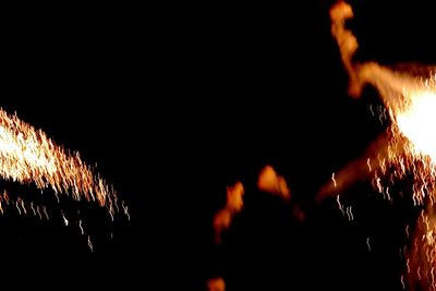 Low angle view of illuminated ferris wheel at night