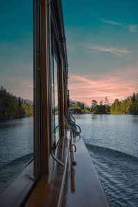 Pier over lake against sky during sunset