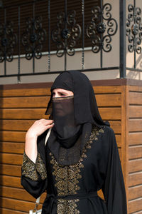 Muslim woman carefully looks distance on a bright sunny day.