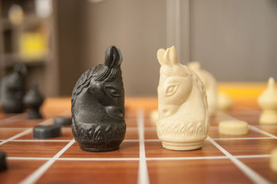 Close-up of knight chess pieces on board