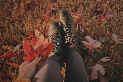 Low section of person standing on field during autumn