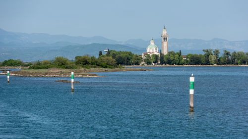 View of lighthouse by sea against sky