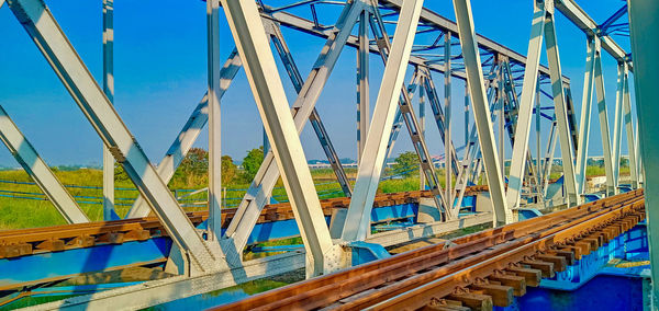 Low angle view of bridge against blue sky