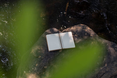 Close-up of open book on rock