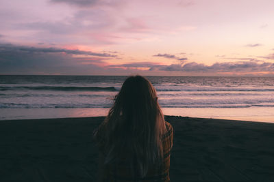 Girl sitting and watching the sunset