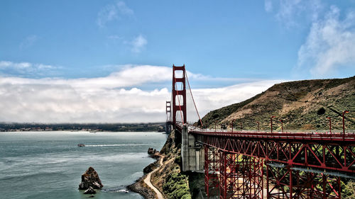 View of suspension bridge against cloudy sky