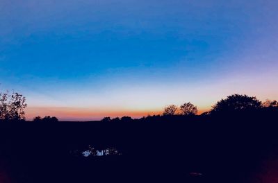 Silhouette trees against sky during sunset