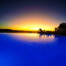 Scenic view of sea against clear sky at sunset