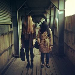 Full length of woman standing in illuminated room