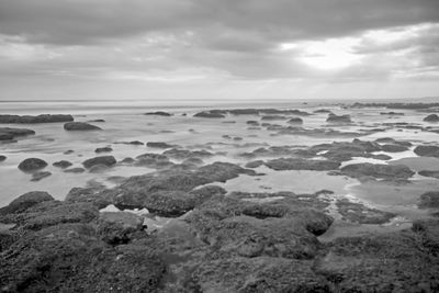 Rocks on beach against sky