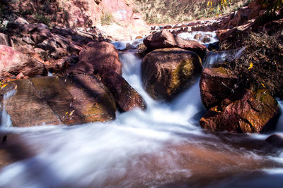 Scenic view of river flowing through rocks