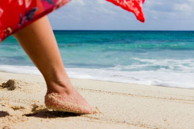 Low section of person standing on beach