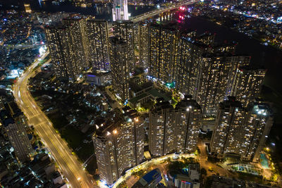 High angle view of city lit up at night