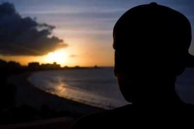 Close-up of silhouette man against sky during sunset