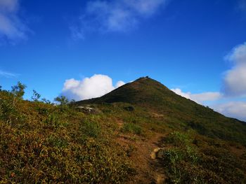 Low angle view of mountain against blue sky