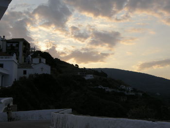 View of townscape against cloudy sky