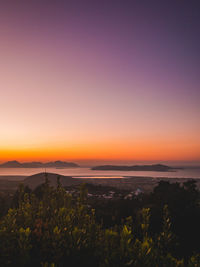 Scenic view of land against sky during sunset