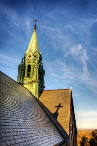 Low angle view of bell tower against sky