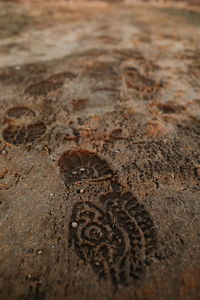 Close-up of rusty metal on sand
