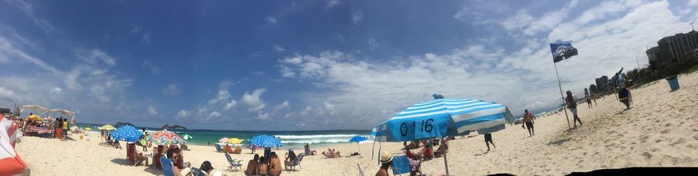 People at beach against sky