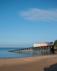 Scenic view of lifeboat station against blue sky