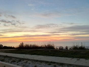 Scenic view of beach against sky during sunset