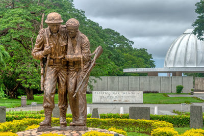 Sculpture in park against sky