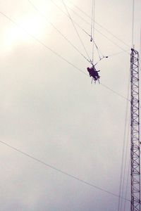 Low angle view of cables against sky