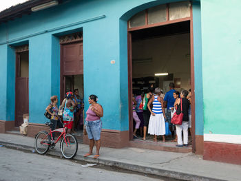 People on street against building