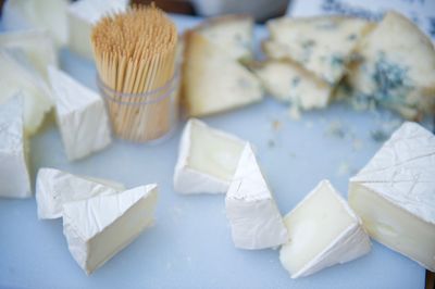 Close-up of sliced cheese with toothpicks on table